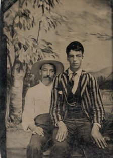 Young Man in a Striped Jacket, Sitting on the Lap of Another Man in Front of Painted..., 1860s-80s. Creator: Unknown.