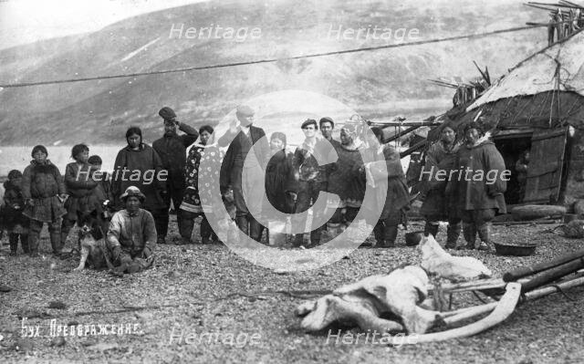 Preobrazhenie Bay: Chukchi in front of their home, in national traditional fur clothing..., 1910-29. Creator: Ivan Emelianovich Larin.