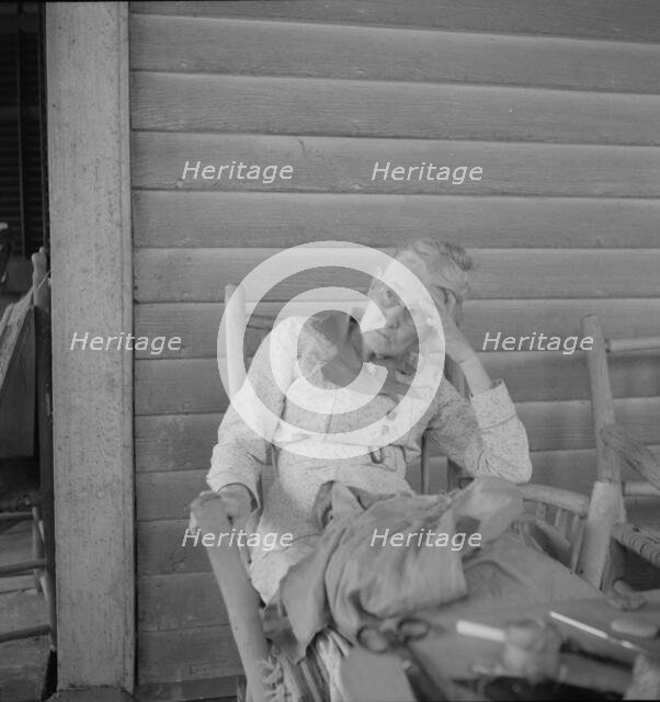 Southern lady on the veranda of the "Big House" at the Wray Plantation, Georgia, 1937. Creator: Dorothea Lange.