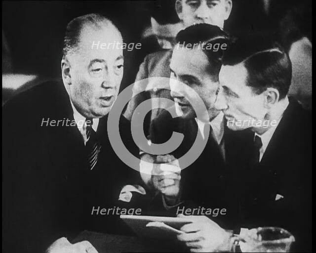 Bruno Richard Hauptmann Talking To His Attorney Edward J. Reilly in a Courtroom During His..., 1930s Creator: British Pathe Ltd.