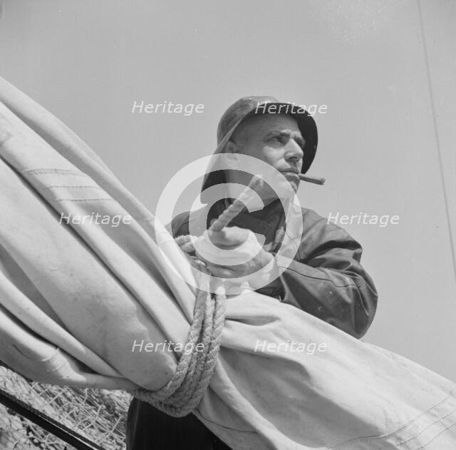A New England fisherman preparing his boat to leave the New York docks, , New York, 1943. Creator: Gordon Parks.