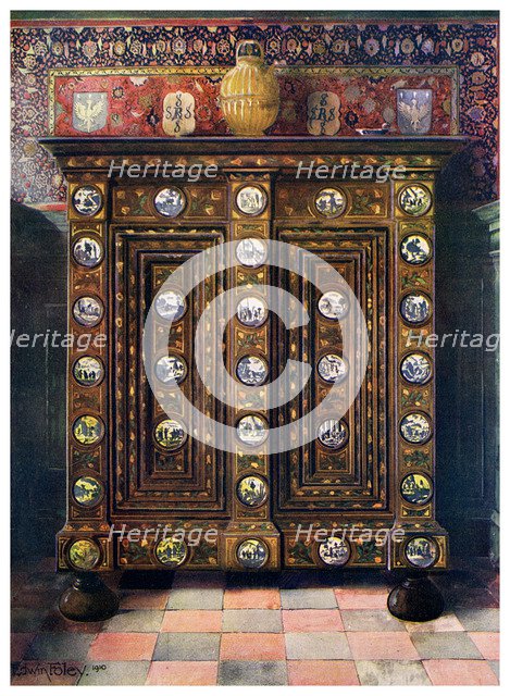 Walnut kas inlaid and with painted medallions of Delft ware, 1910.Artist: Edwin Foley