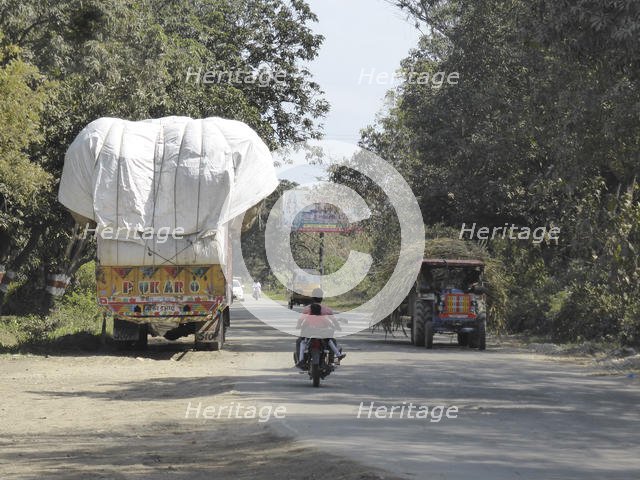 Trucks with heavy loads of sugar cane, Uttarakhand, India. Creator: Unknown.