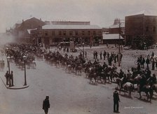 South Africa: Boer soldiers riding through a street in a South African town, 1896. Creator: Barnett.