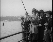 Female Civilian Fishing from a Pier Watched by a Small Crowd, 1920. Creator: British Pathe Ltd.