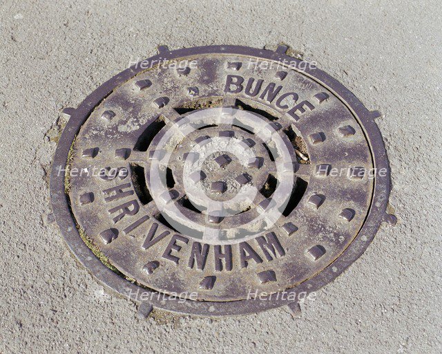 Drain cover plate made by Bunce of Shrivenham, Swindon, Wiltshire, 2006.  Artist: Peter Williams.