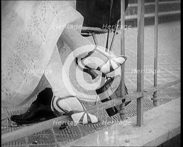 Female Civilian Wearing a Smart Heeled Pair of Shoes in Stripes, 1920. Creator: British Pathe Ltd.