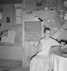 Mrs. Hull in one-room dugout basement home, Dead Ox Flat, Malheur County, Oregon, 1939. Creator: Dorothea Lange.