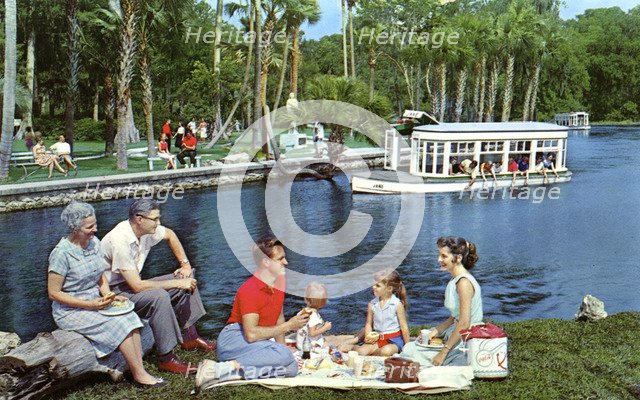 A family having a picnic beside the water, Silver Springs, Florida, USA, 1959. Artist: Mozert