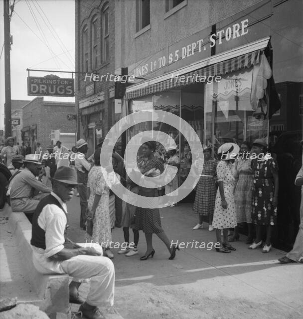Saturday afternoon - shopping and visiting on main street of Pittsboro, North Carolina, 1939. Creator: Dorothea Lange.