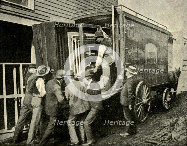 'Loading The Camera On A Van For Removal', 1901. Creator: Unknown.