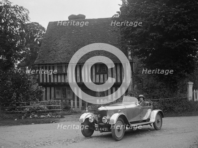 Two women in a AC motor car in front of a Tudor house, c1930s Artist: Bill Brunell.