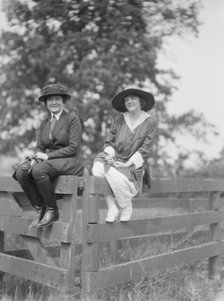 Bruce, Mrs., and Miss Hedman, seated outdoors on a fence, 1919 May 30. Creator: Arnold Genthe.