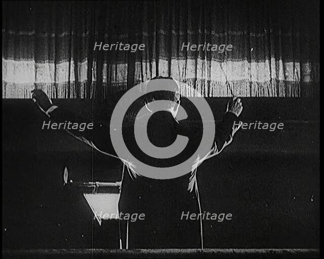 Conductor and Orchestra Performing As the Curtain Raises, 1920s. Creator: British Pathe Ltd.