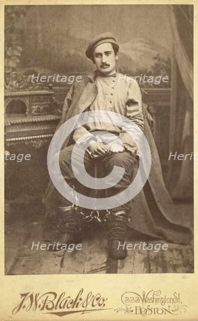 Full-length portrait of a man in convict clothing and leg irons, seated..., between 1880 and 1886. Creator: Unknown.