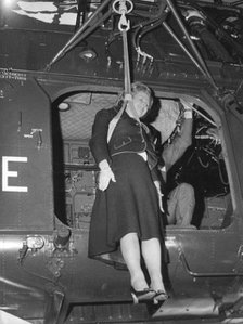Margaret Thatcher is airlifted aboard an air-sea rescue helicopter, 12th January 1978. Artist: Unknown