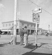 Idle pea pickers discuss prospects for work, Calipatria, Imperial Valley, California, 1939. Creator: Dorothea Lange.