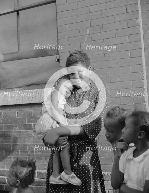 Young girl with her sister who live on Seaton Road, Washington, D.C., 1942. Creator: Gordon Parks.