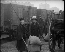 Two Elderly Female Civilians Wheeling a Barrow of Coal Away from a Railway Truck As Other..., 1924. Creator: British Pathe Ltd.