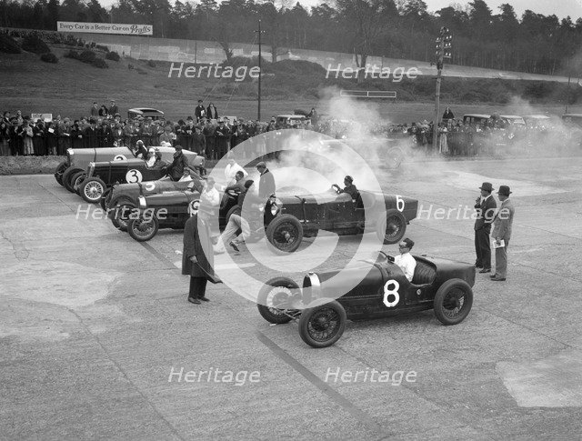 Cars on the start line at a BARC meeting, Brooklands, 1930. Artist: Bill Brunell.
