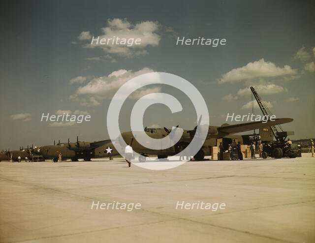 Loading new transport planes at the Consolidated Aircraft Corporation plant, Fort Worth, Texas, 1942 Creator: Howard Hollem.