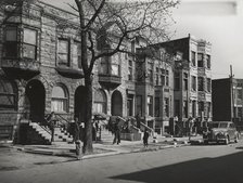 Old brown stonehouses now occupied by Negroes in Chicago, Illinois, April 1941. Creators: Farm Security Administration, Russell Lee.
