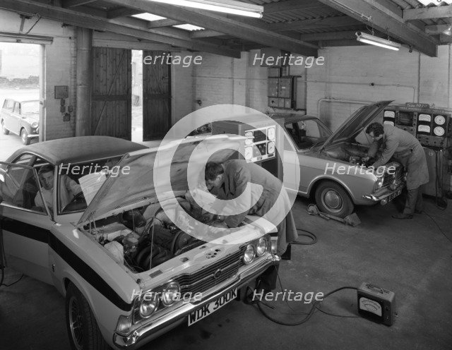 Cortina Mk 2 and Mk3 GT in a garage being serviced/modified, 1972. Artist: Michael Walters