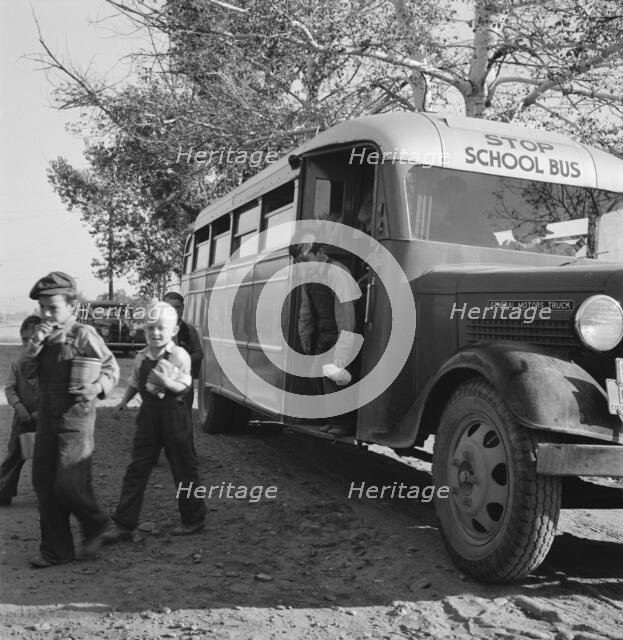 The children from Dead Ox Flat get off bus at school yard, Ontario, Oregon, 1939. Creator: Dorothea Lange.