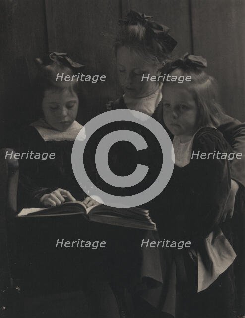 Three young girls reading a book, c1900. Creator: Gertrude Kasebier.