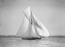 The gaff rigged cutter 'Bloodhound' sailing downwind with spinnaker, 1911. Creator: Kirk & Sons of Cowes.