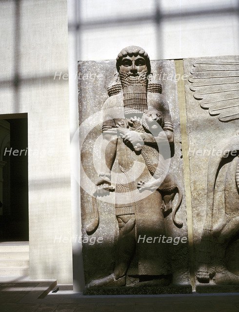 Assyrian sculpture of a man holding a lion, Khorsabad, c8th century BC. Artist: Unknown