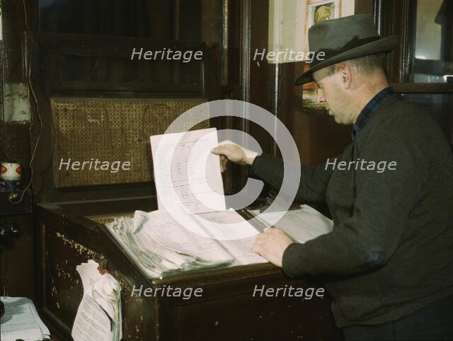 Switch lists coming in by teletype to the hump office at a C& NW RR yard, Chicago, Ill., 1942. Creator: Jack Delano.
