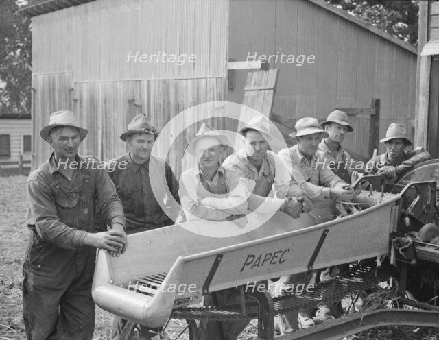 Seven of the eight farmers shown with their coop...West Carlton, Yamhill County, Oregon, 1939. Creator: Dorothea Lange.