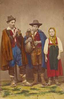 Three Italian peasants standing: two men playing wind instruments, a girl next to them, 1865-1875. Creator: Giorgio Conrad.