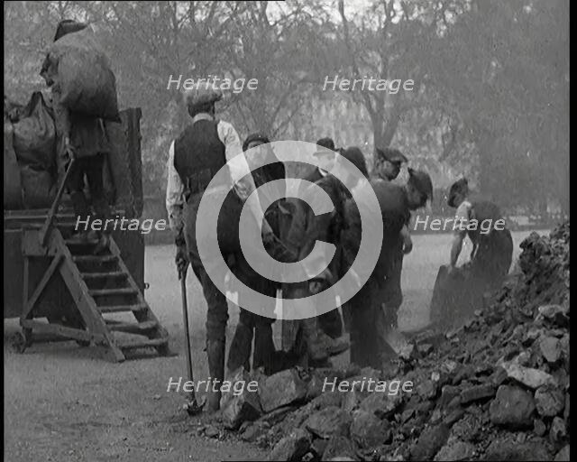 Male Civilian Volunteers Shovelling Heaps of Coal in Hyde Park London, 1926. Creator: British Pathe Ltd.