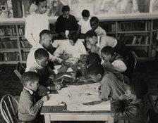 Oliver Harrington supervises class studying mural work, Hudson Ave Boys' Club, 1936. Creator: Andrew Herman.