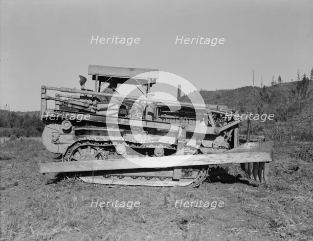 Caterpillar clearing land on cut...western Washington farm, Lewis County, Western Washington, 1939. Creator: Dorothea Lange.