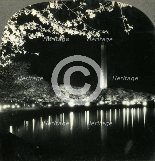 'When It Is Cherry Blossom Time in Washington - A Lovely Night View of Washington Monument', c1930s. Creator: Unknown.