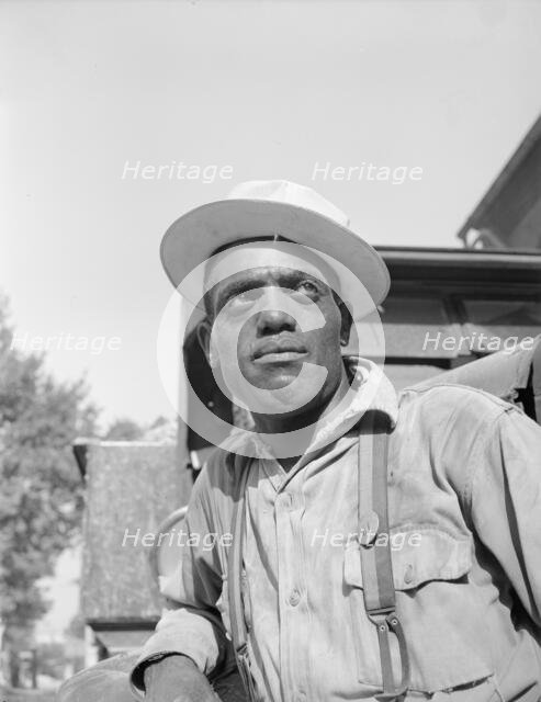 Laborer listening to instructions being given by a section foreman, Washington, D.C, 1942. Creator: Gordon Parks.