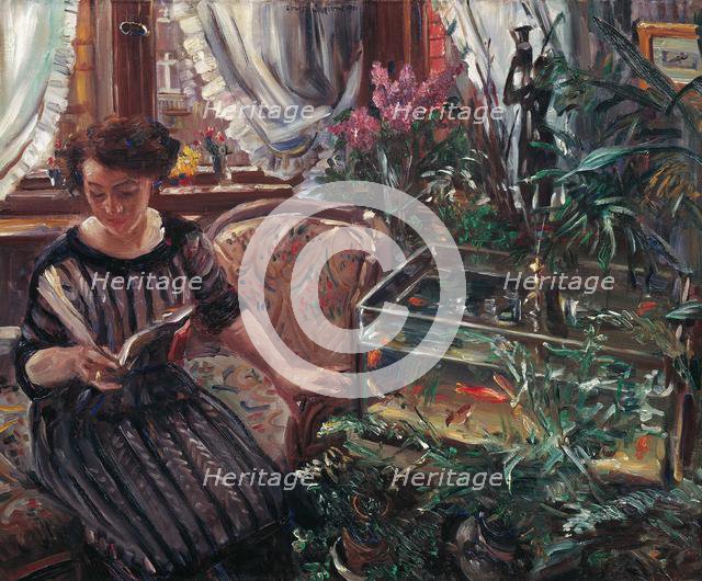 A Woman Reading near a Goldfish Tank, 1911. Creator: Corinth, Lovis (1858-1925).