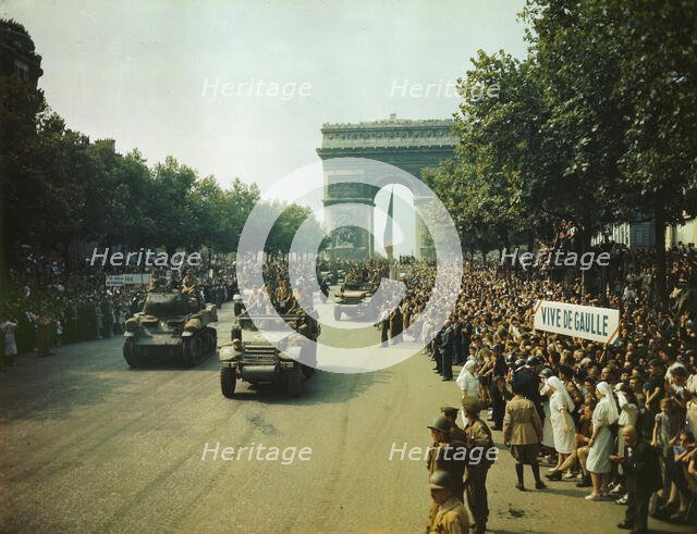 Crowds of French patriots line the Champs Elysees to view Allied tanks and half tracks pass..., 1944 Creator: Jack Downey.