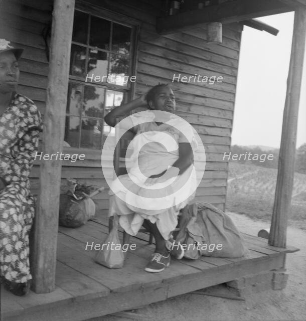Possibly: Mother of sharecropper family and friend...the rain, Person County, North Carolina, 1939. Creator: Dorothea Lange.