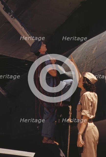 Mrs. Cora Ann Bowen (left) works as a cowler at the Naval Air Base..., Corpus Christi, Texas, 1942. Creator: Howard Hollem.