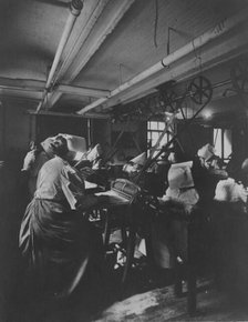 Women perforating sheets of stamps in the Stamp Division at the Bureau of Engraving..., c1895. Creator: Frances Benjamin Johnston.