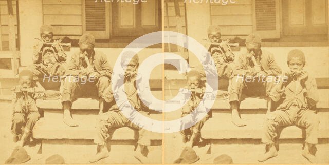 Distinguished southerners, grinding cane. [Children chewing sugar cane on the porch], (1868-1900?). Creator: Unknown.