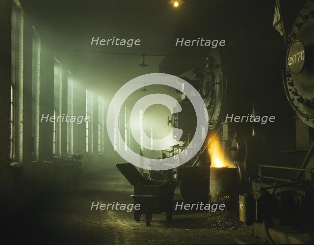 In the roundhouse at a Chicago and North Western Railroad yard, Chicago, Ill., 1942. Creator: Jack Delano.