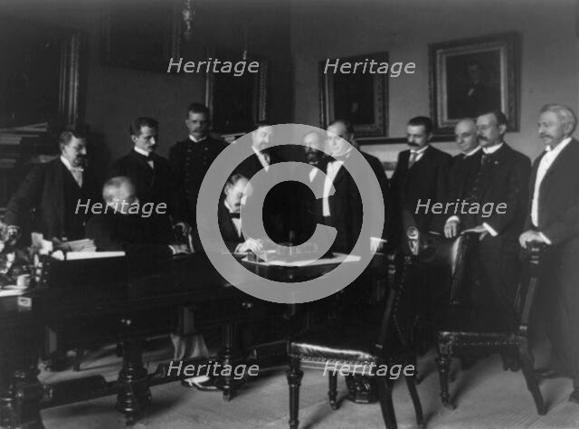 Cabinet Room, White House, Aug. 12, 1898. Secy. of State William R. Day signing, c1898. Creator: Frances Benjamin Johnston.