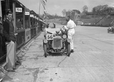 J Reeves and HHB Beacon's Austin Ulster in the pits, JCC Double Twelve race, Brooklands, 1931. Artist: Bill Brunell.