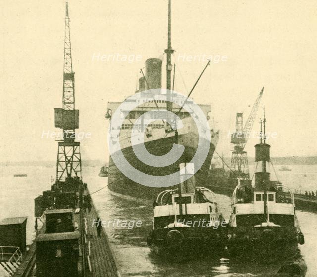 'The "Majestic" Entering Dry Dock Hauled by Tugs', c1930. Creator: Unknown.
