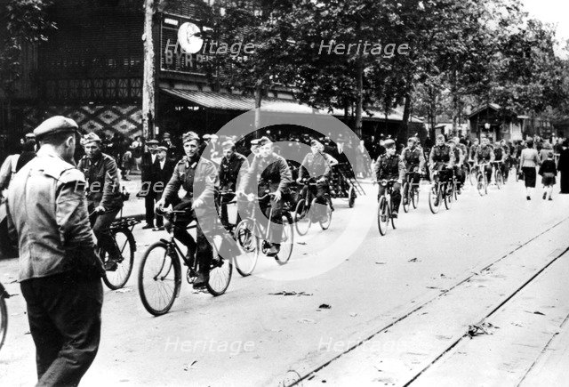 German soldier cycling through the streets of Paris, June 1940. Artist: Unknown